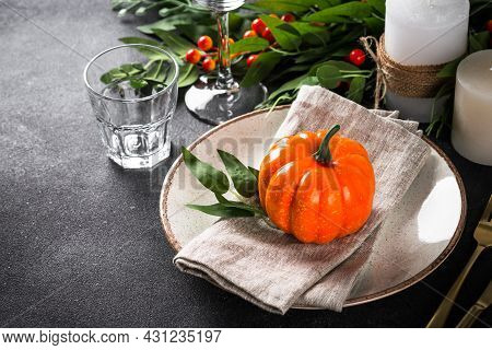 Autumn Table Setting With Plate, Pumpkin And Candles.