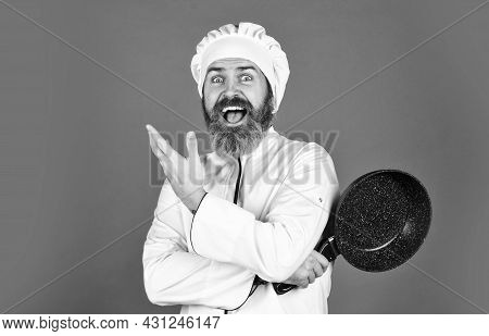 Bearded Cook Uniform Man Hold Cooking Pan. Cooking Like Pro. Easy Cheap Tasty Meals Prepared At Home