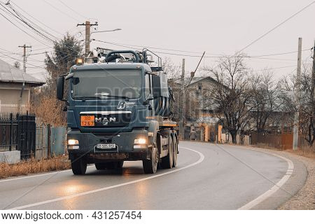 Cars On The Asphalt Road. Utility Car (from Rohrer Group Company) In Traffic.  Targoviste, Romania, 