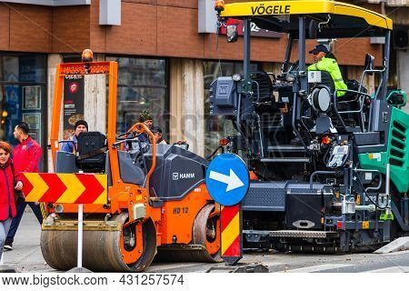 Workers In Overalls In An Autumn Morning Repair The Street On The Main Boulevard Victoriei (calea Vi