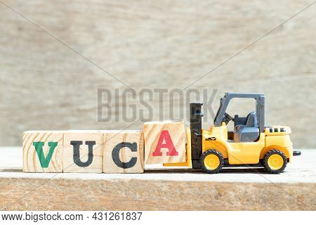 Toy Forklift Hold Letter Block A To Complete Word Vuca (abbreviation Of Volatility, Uncertainty, Com