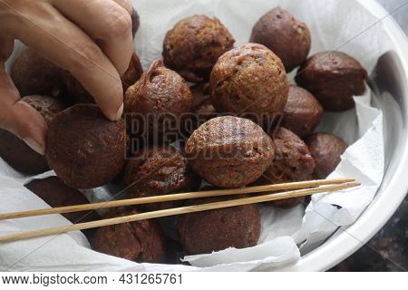 Rice Fritters Made With A Batter Of Rice Flour, Banana, Jaggery And Roasted Coconut Pieces. Made In