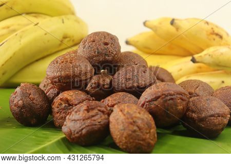 Rice Fritters Made With A Batter Of Rice Flour, Banana, Jaggery And Roasted Coconut Pieces. Made In