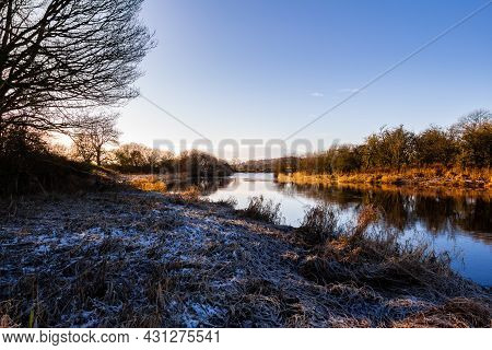 A Winter Scene On The River Dee At Threave Castle, With Snow And Frost On The Ground, On A Sunny Win