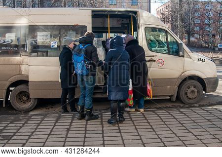 Petrozavodsk, Russia - 17 March 2020. People Get Into The Minibus At The Bus Stop. Minibus As Public