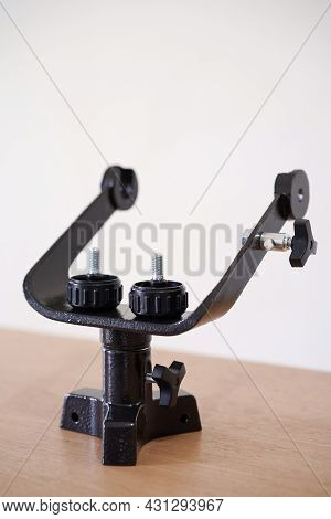 Yoke Altazimuth Mount, Thumb Screw, And Vertical Fine Adjustment Rod. Telescope Parts On Wooden Tabl