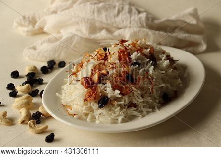 Rice Dish Made Of Basmati Rice, Ghee And Spices And Garnished With Fried Onions And Cashews. Commonl