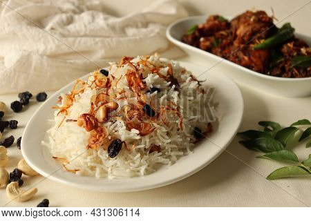 Rice Dish Made Of Basmati Rice, Ghee And Spices And Garnished With Fried Onions Served With Kerala S