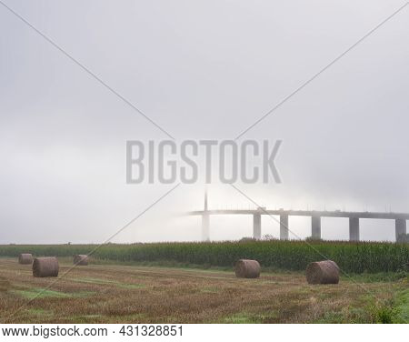 Meadow Landscape And Pont De Brotonne Over River Seine In French Normandy During Misty Sunrise