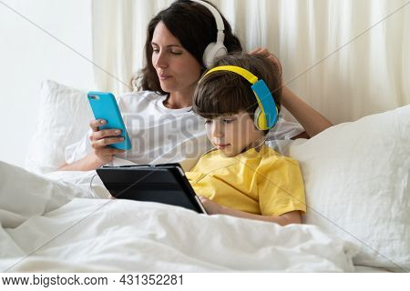 Lazy Family Parent And Kid Spent Morning Lying In Bed. Single Mother Does Grocery Shopping Online In