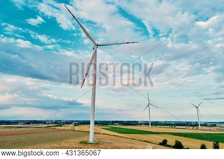 Windmill Among Agricultural Fields. Wind Turbine Generator At Summer Day. Wind Energy Concept, Suist