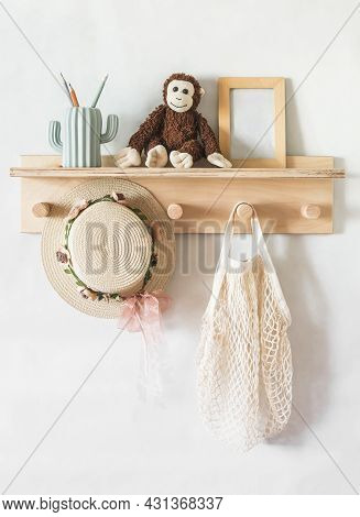 Wooden Shelf In The Children's Room On The Wall With Toys, A Children's Straw Hat, A Bag. Interior C