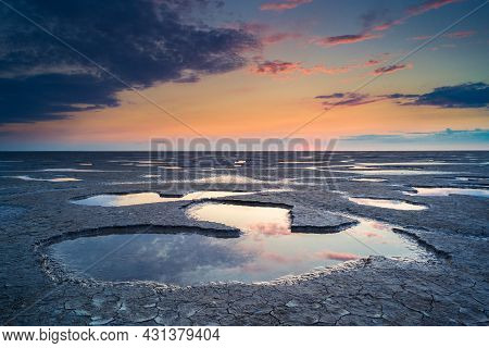 Wadden Sea In The Netherlands During Sunset With Wid Angel View And Colorful Clouds.