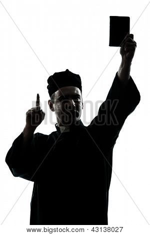 one caucasian man priest wrath of god  silhouette in studio isolated on white background