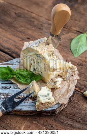 French Cheeses Blue Cheese Dorblu, Gorgonzola, Roquefort On Wooden Table. Vertical Image. Top View. 