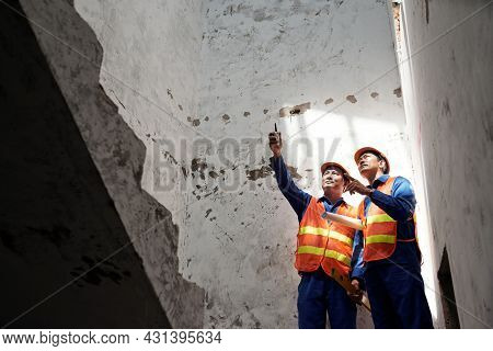 Head Engineer And Contractor Standing On Staircase And Discussing Stability Of Boarding Jois