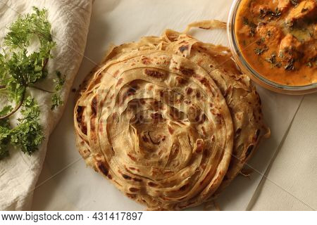Parotta Or Porotta, A Layered Flatbread Made Of Maida. This Flaky Ribbon Pancake Is A Favourite Of K