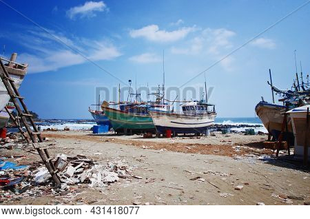 Dondra Port, Sri Lanka. Abandoned Fishing Boats On The Shore. Dirty Harbor And Old Ships.