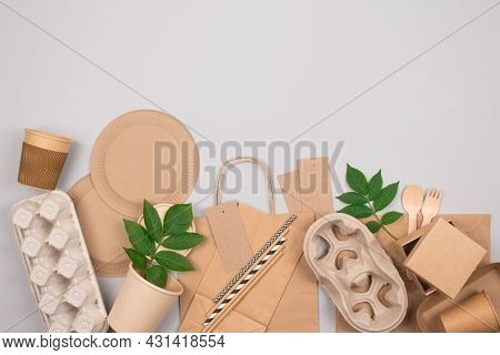 Eco-friendly Sustainable Packaging And Tableware Set - Kraft Paper Food Packaging On Gray Background