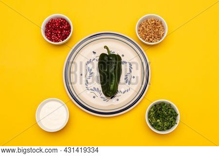 Green Chili On A Plate And Some Ingredients For Cooking Chiles En Nogada, Traditional Dish From Mexi