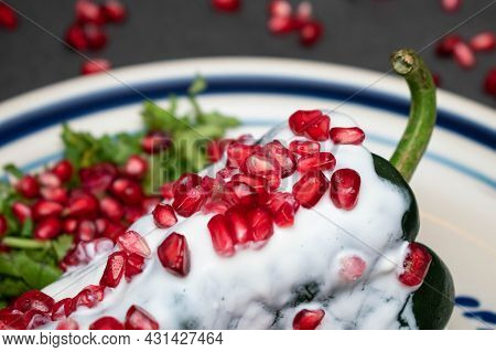 Close Up Of Chile En Nogada, Typical Mexican Dish On Black Background