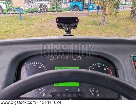 View Of The Dashboard Of The Bus From The Driver's Seat. Through The Windshield View Of The Bus Park