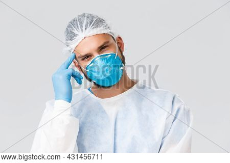 Covid-19 Pandemic, Virus Outbreak, Clinic And Healthcare Workers Concept. Young Thougtful Doctor In 