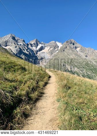 trail for hikers.  in the background the peaks of the Meije.  la Grave, France.
