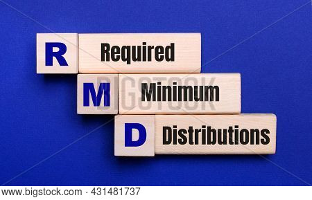 On A Bright Blue Background, Light Wooden Blocks And Cubes With The Text Rmd Required Minimum Distri