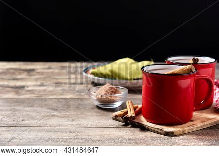 Traditional Mexican Chocolate Atole Drink On Wooden Table. Copy Space