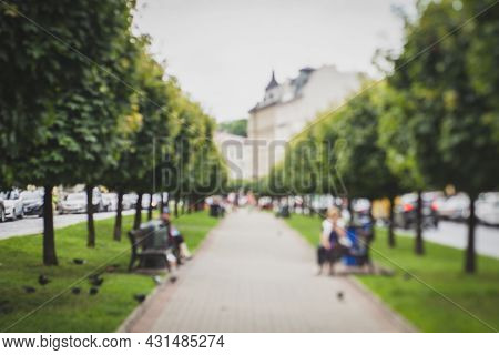 Natural Bokeh Of Blurry View Of A Park Or Alley, Blurred Out Of Focus Background. Abstract Beautiful