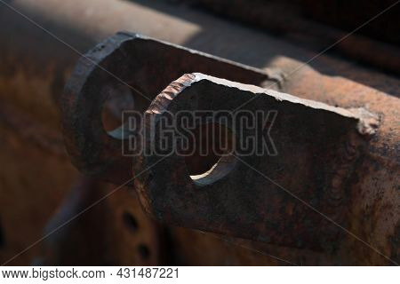 Close-up Of An Old Rusty Traverse Of A Rotten Tow Truck With Two Metal Eyelets