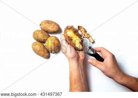 The Guy Peels Potatoes On A White Background, In The Hands Of A Rotten Potato