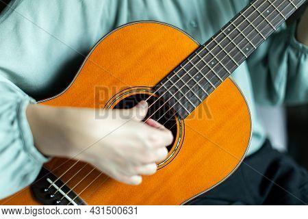 Close Focus On Strings And Fingerboard Of Wooden Solid Spruce Acoustic Guitar Strumming By Blurry Ha