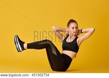 Girl In Black Sportswear Doing V-ups Abs Workout