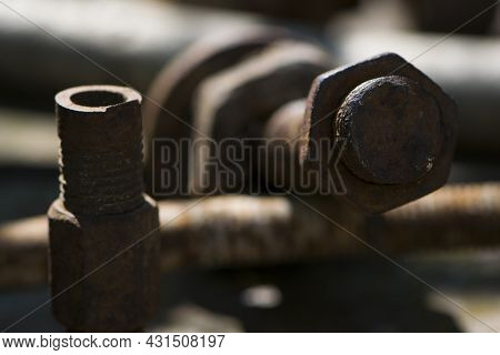 Old Rusty Bolt, Iron Rod With Screw Threads. Rusted Mechanical Components. Threaded Bolt And Nut. Di
