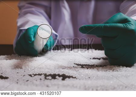 Man Hands Wearing Gloves Hold Polymer Pallet. Plastic Beads On Green Gloved Hand. Polymer Beads. The