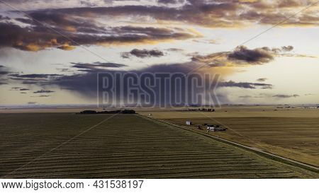Aerial View Of An Isolated Storm Over Crop Swaths On The Canadian Prairies.