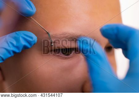Man With Pierced Eyebrow. Three Small Black Piercings.