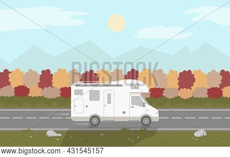 A Camper Or A Caravan Is Driving On A Motorway On Autumn Background.