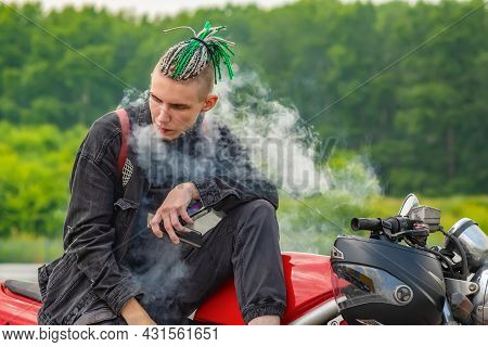 A Guy, A Teenager, A Man Of Non Standard Informal Appearance With Pigtails On His Head, Dreadlocks A