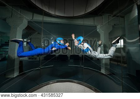 A Man And A Woman Enjoy Flying Together In A Wind Tunnel. Free Fall Simulator
