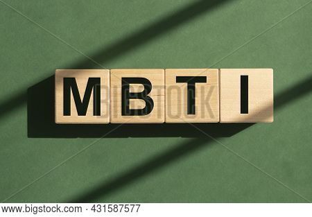 Mbti Word On Wood Cubes On Green Background.