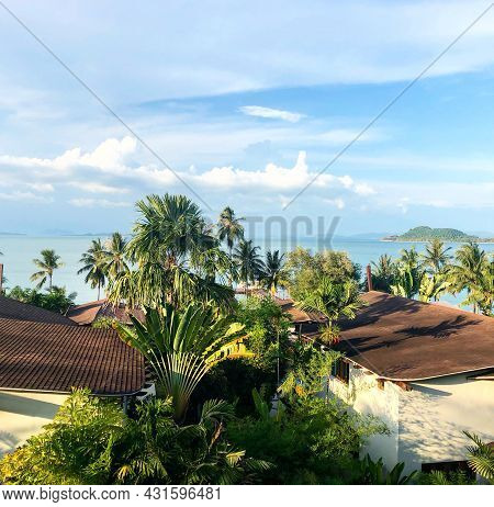 Aerial View Of Red Roofs Of Houses, Palms And Ocean. Tropical Landscape On Island. Clouds And Blue S