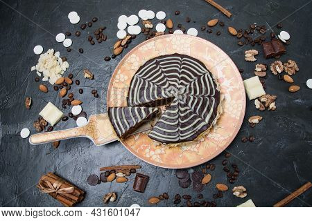 Chocolate Sliced Esterhazy Cake With Cream, Frosting, Nuts, Cinnamon And Almonds Close-up View From
