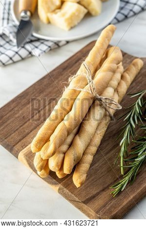 Grissini sticks. Traditional italian bread sticks on cutting board.