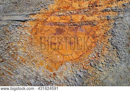 Dried Rusty Pool With Tire Tracks And Rough Grey Contaminated Land Texture From Abandoned Pyrite Min
