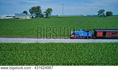 Ronks, Pennsylvania,june 2019 - Aerial View Of Thomas The Tank Engine Approaching Thru Trees And Far