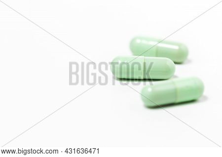 Green Chiretta Herbal Capsule On White Background With Copy Space For Healthcare And Medical Concept