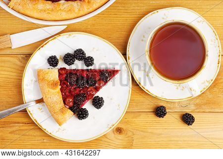 Piece Of Homemade Open Pie Gallet With Raspberries, Blackberry And Grapes. Top View.